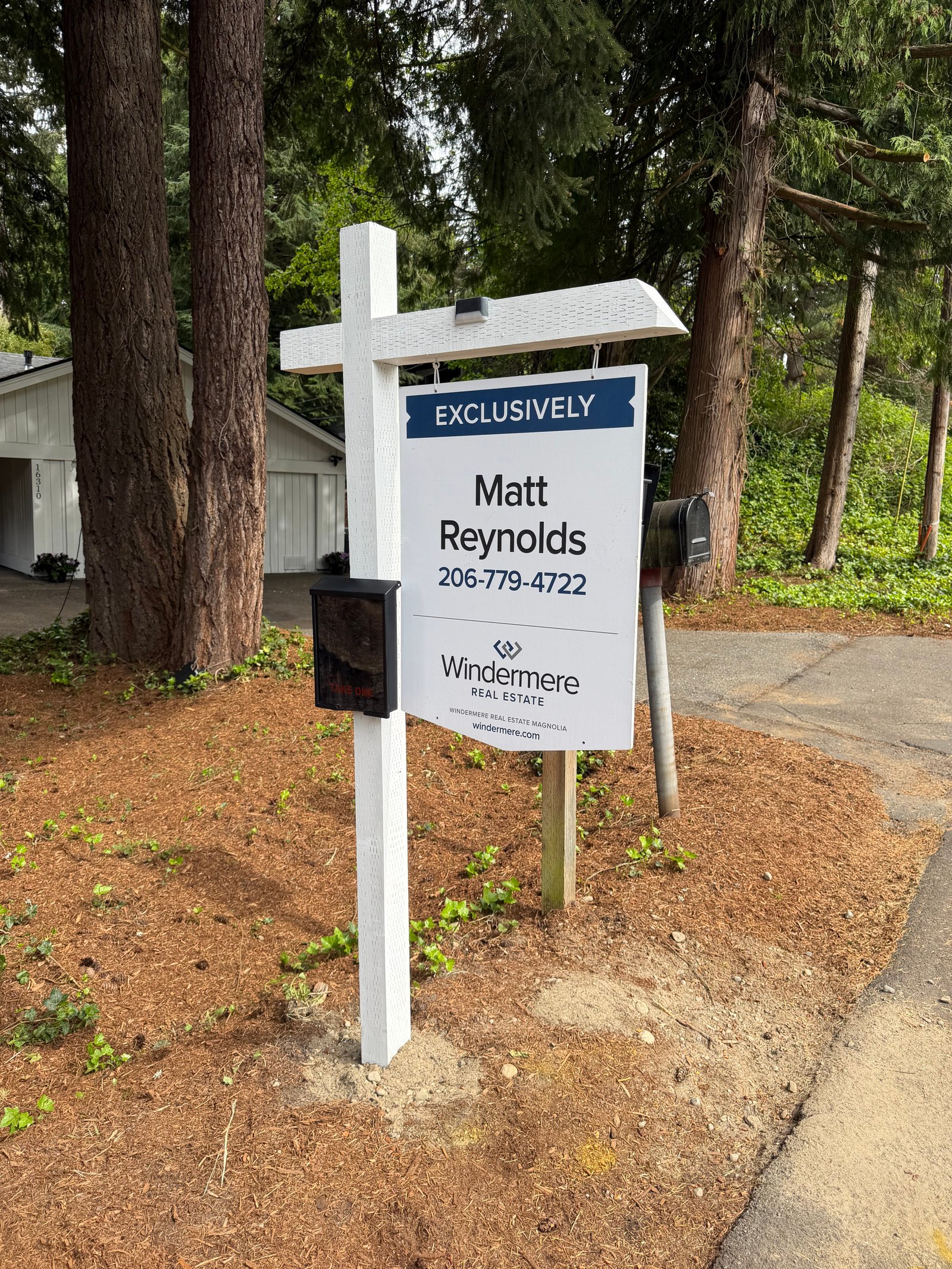Real estate listing sign installed in a Seattle front yard
