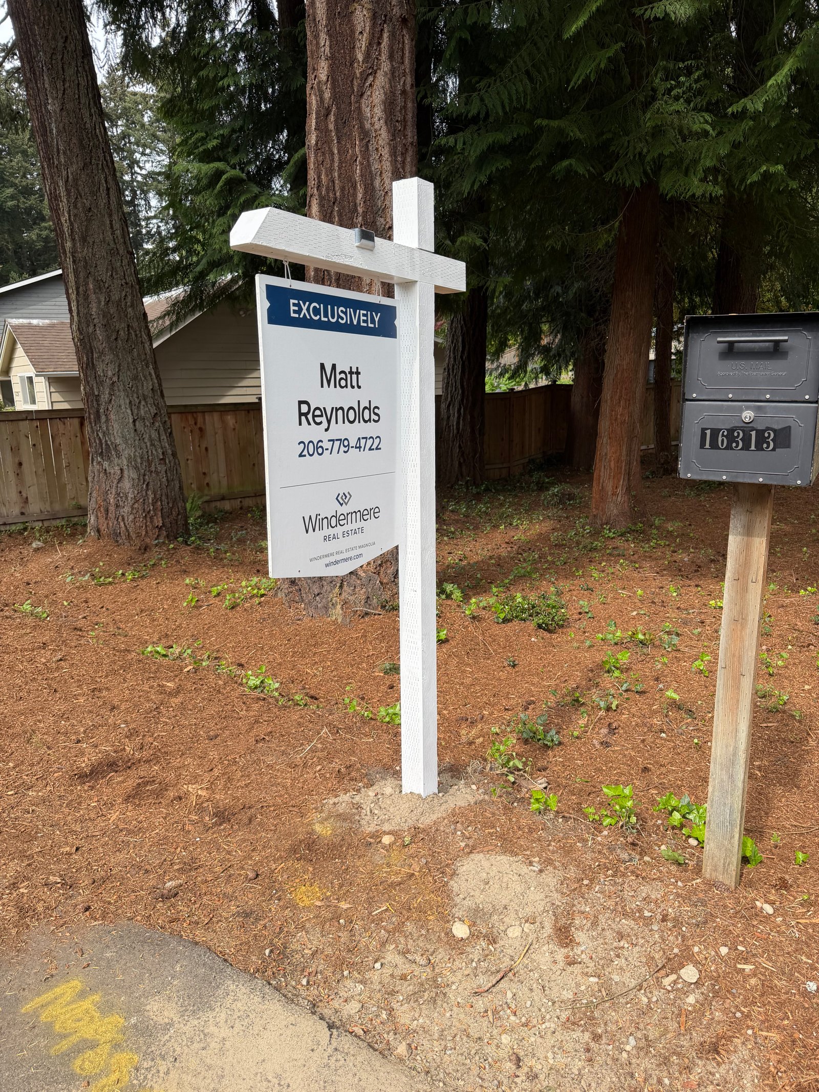 Installed real estate sign and post at curbside listing