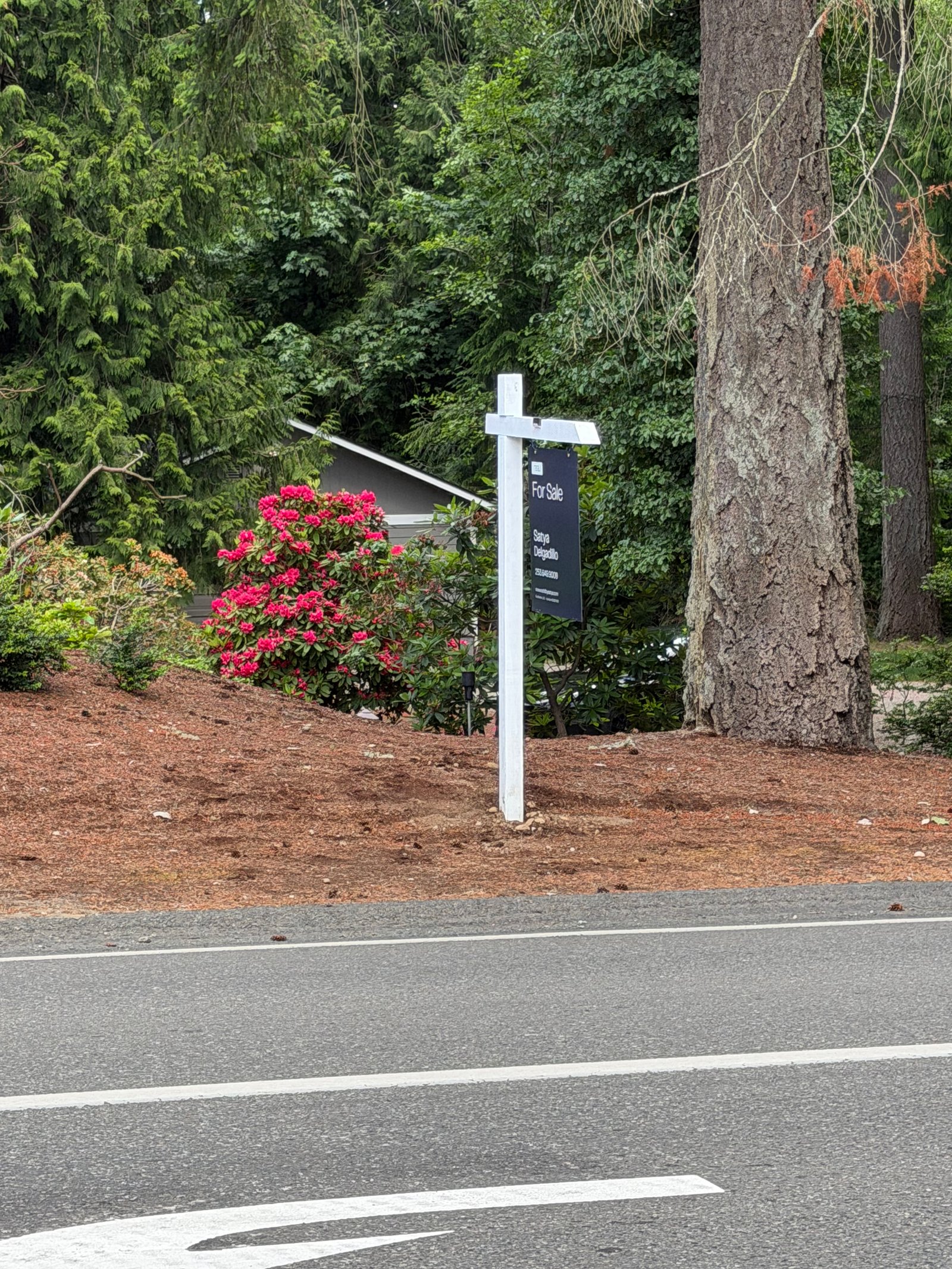 Installed listing sign with landscaping and curb appeal