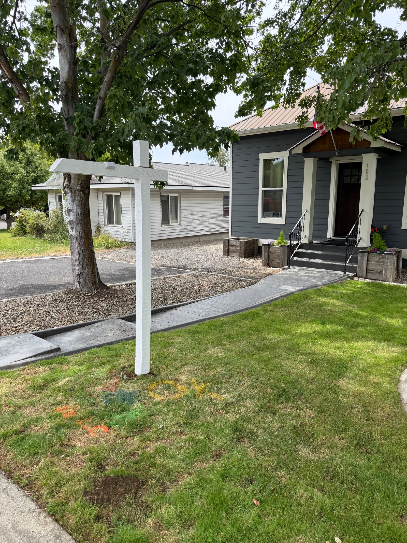 Listing sign installed in front of a single-family home