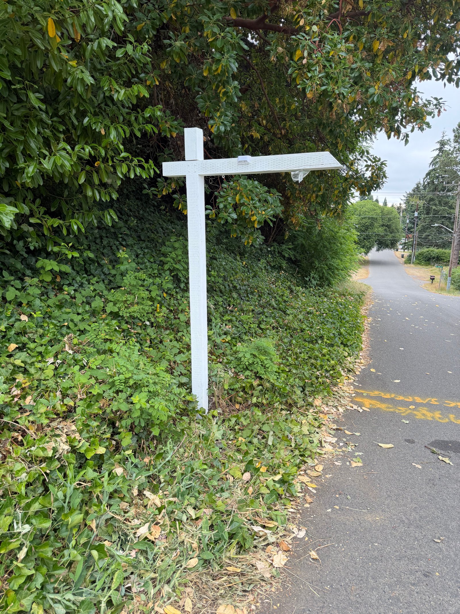 Installed listing sign positioned for neighborhood street visibility