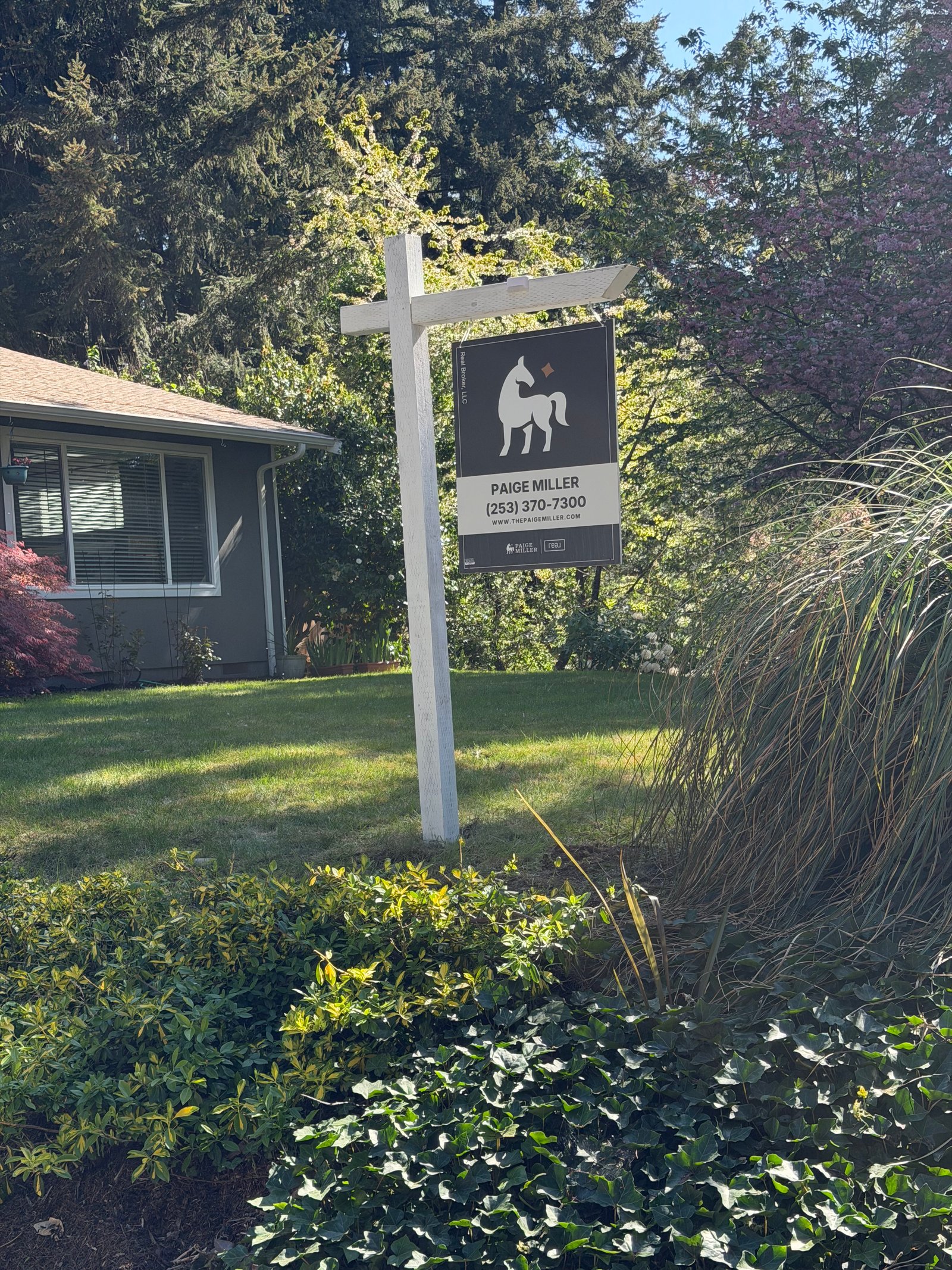 Installed signpost with branded panel on residential lot
